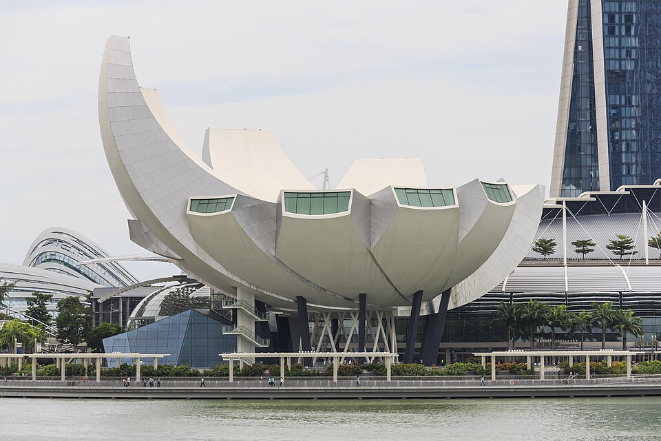 Close-up of the ArtScience Museum's white petal-like roof structure and supporting columns by the waterfront