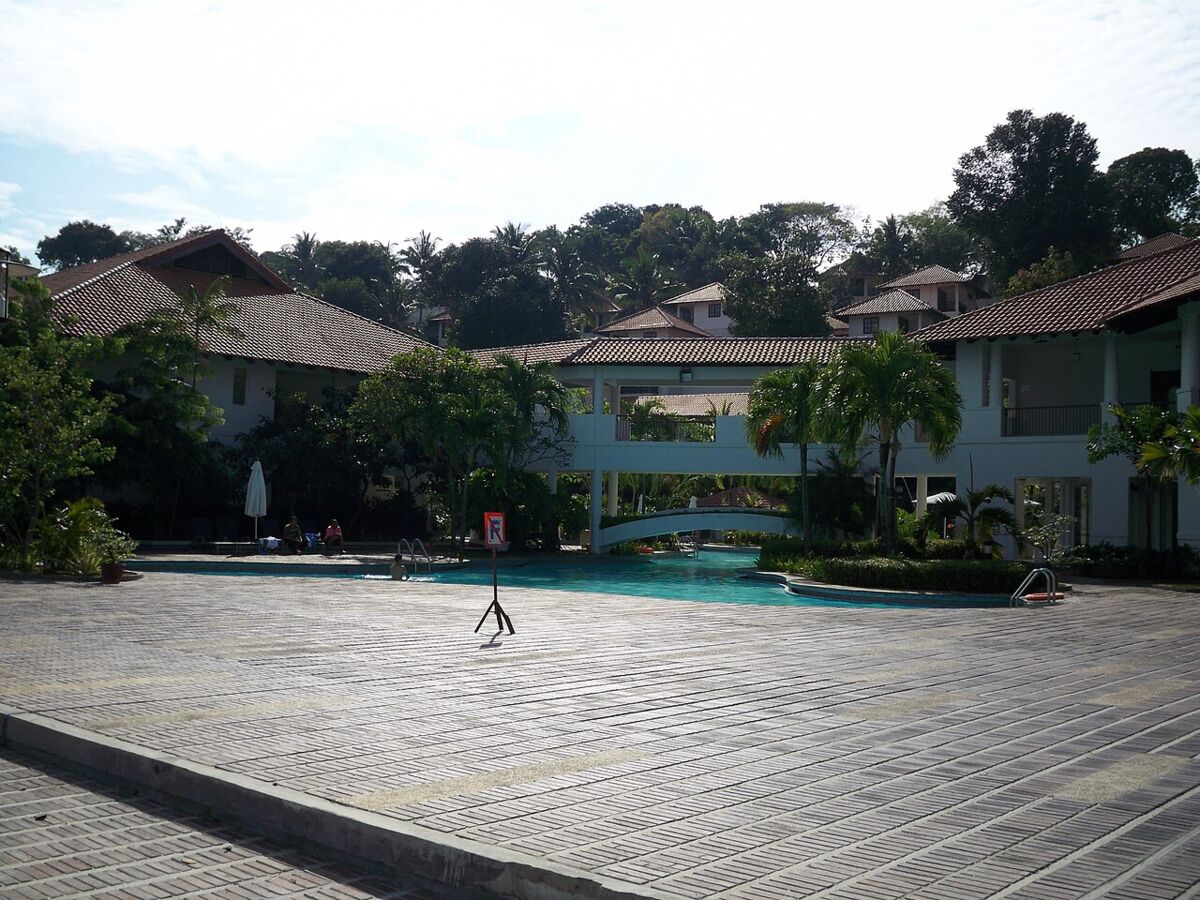 Garden swimming pool flanked by tiled-roof villas at Nongsa Point Marina Resort, Batam