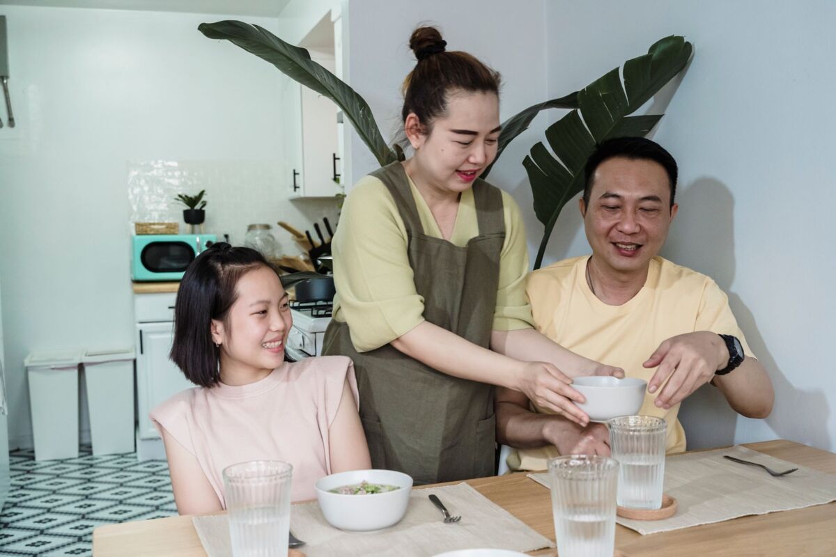 Family having a joyful breakfast time together, enjoying a meal at home.