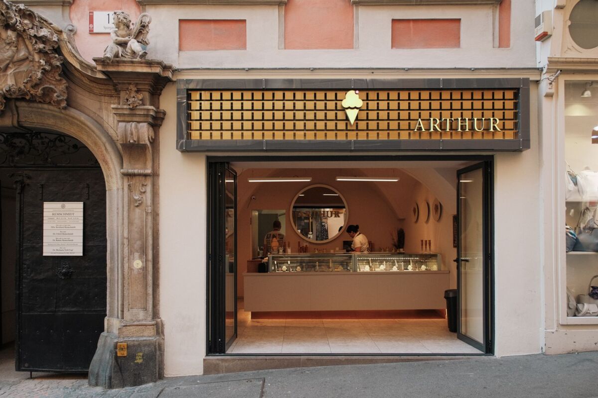 A stylish gelato shop entrance in Graz, featuring a welcoming design and classic architecture.