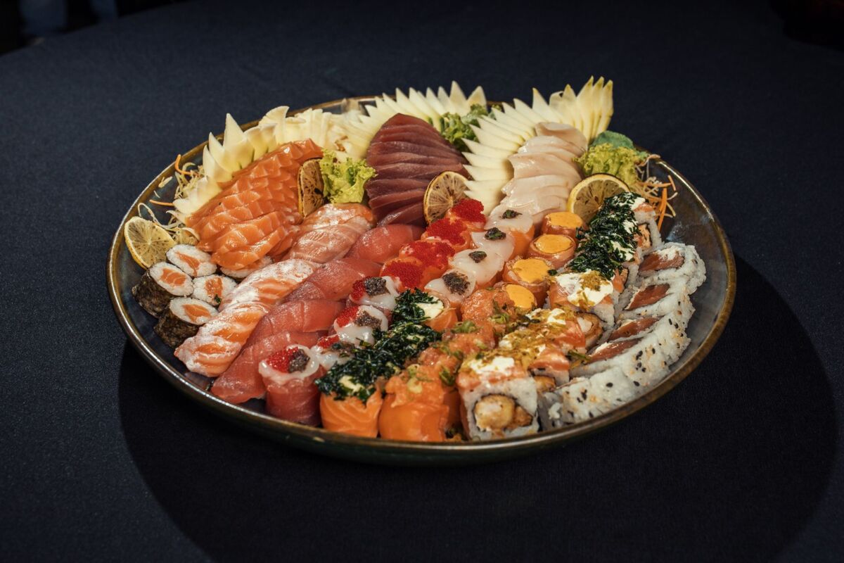 A vibrant sushi platter showcasing various types of sashimi and rolls, beautifully arranged.