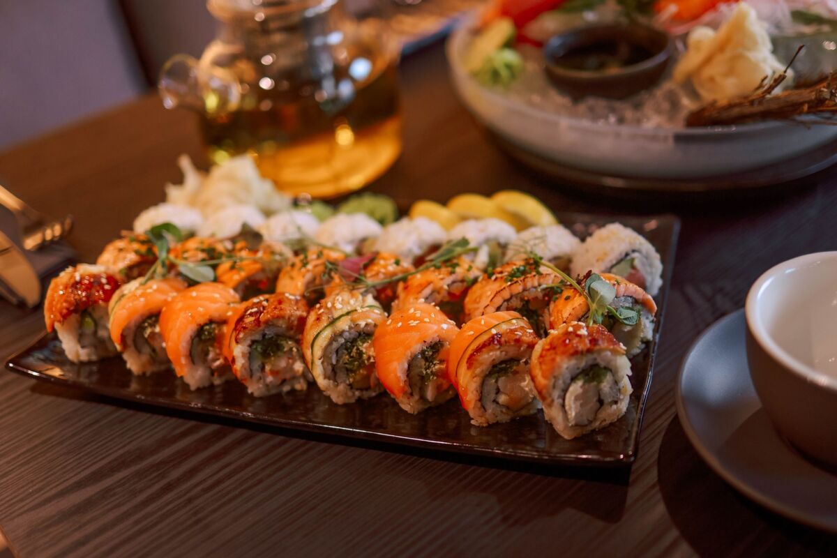 Delicious sushi rolls served with tea in an elegant restaurant setting.