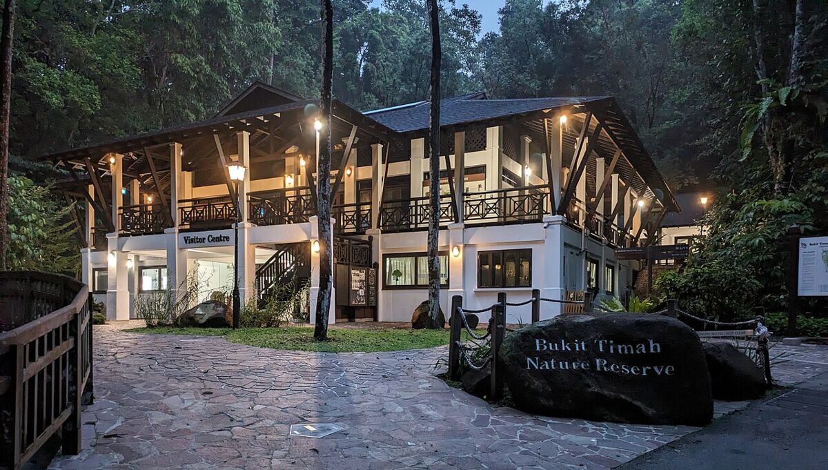 The Bukit Timah Nature Reserve Visitor Centre building lit up with its name on a boulder out front