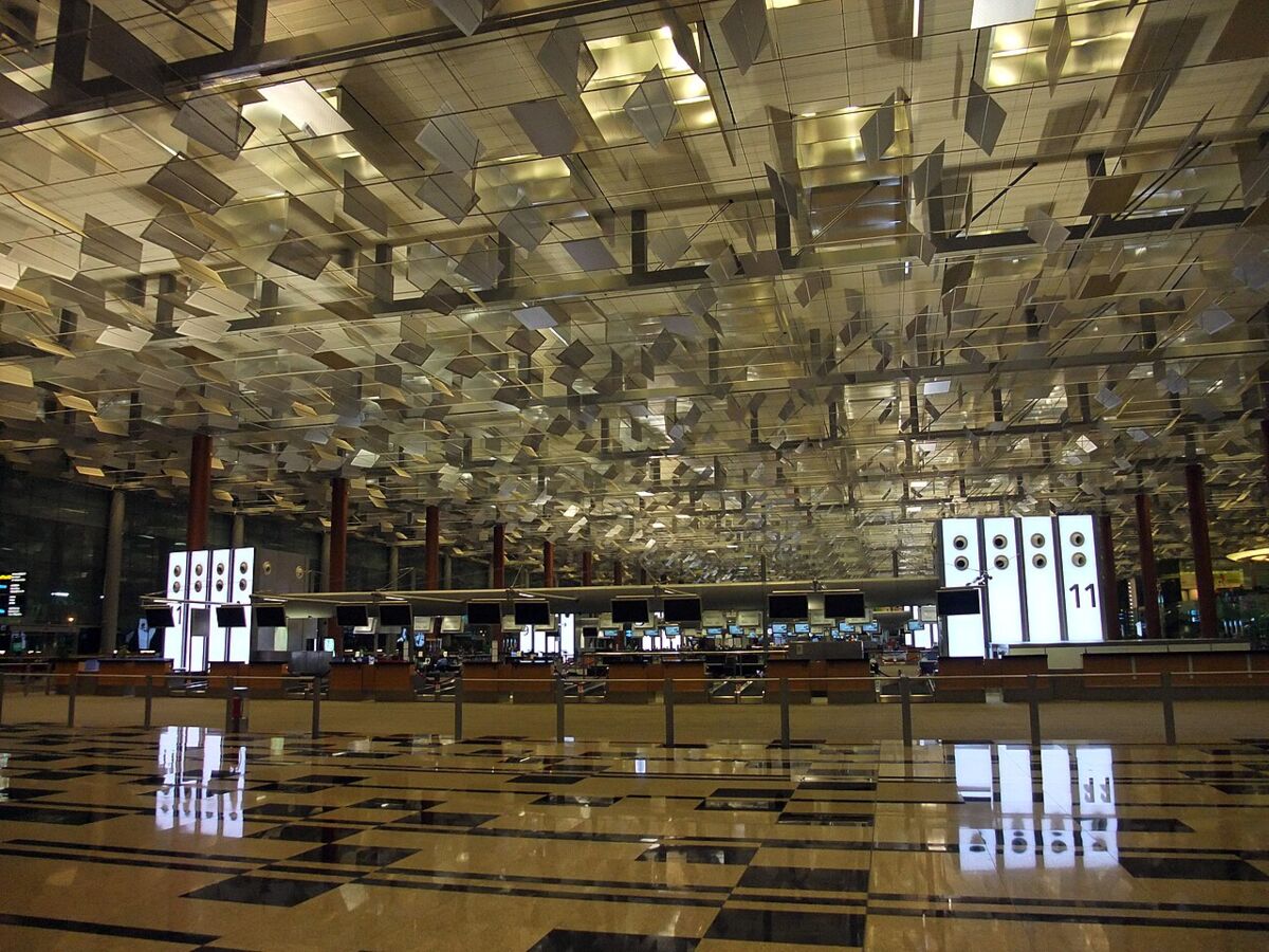 Check-in hall at Changi Airport with the distinctive mirrored sculptural ceiling and reflective marble floor