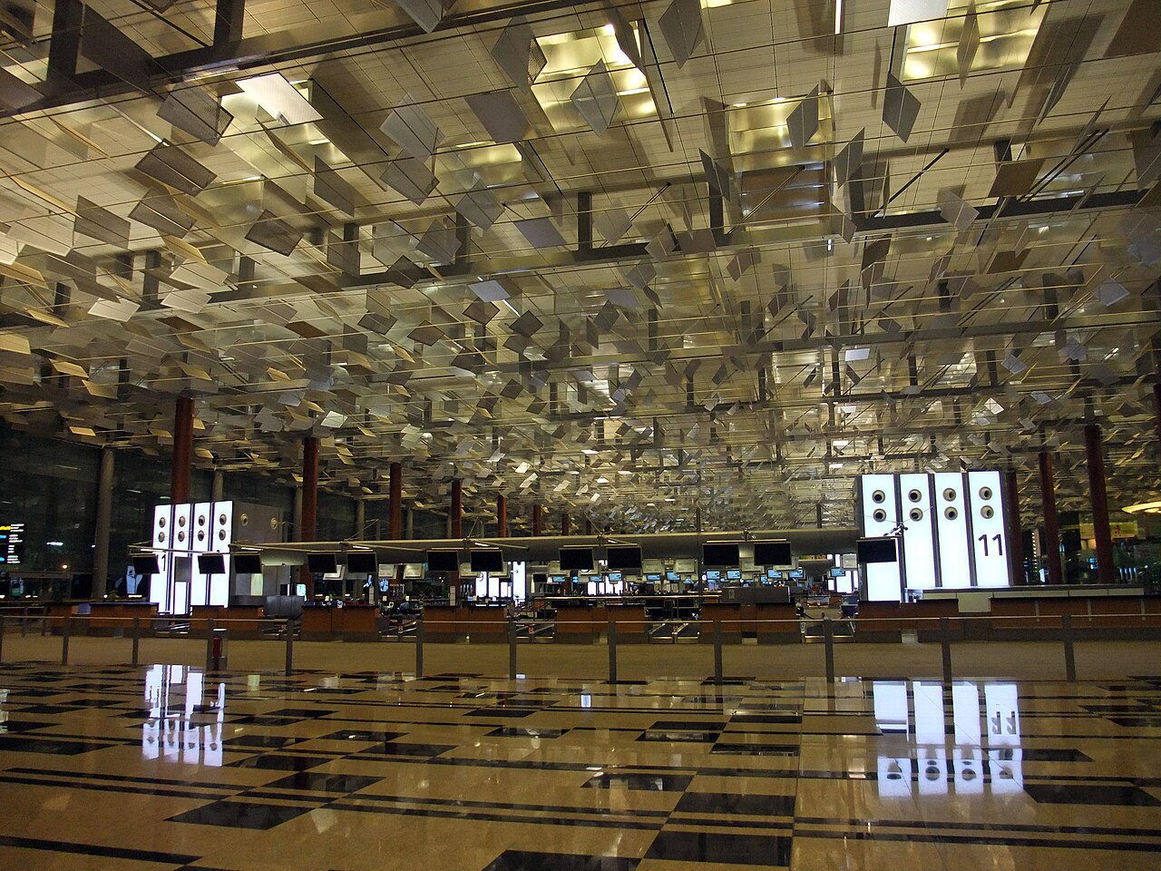 Check-in hall at Changi Airport with the distinctive mirrored sculptural ceiling and reflective marble floor