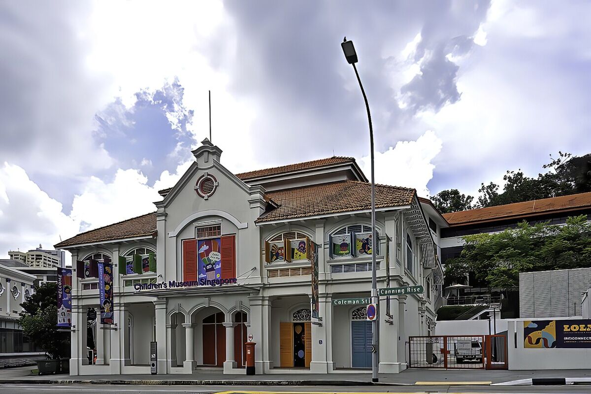 Children's Museum Singapore heritage building exterior with dramatic cloudy sky at the corner of Coleman Street and Canning Rise