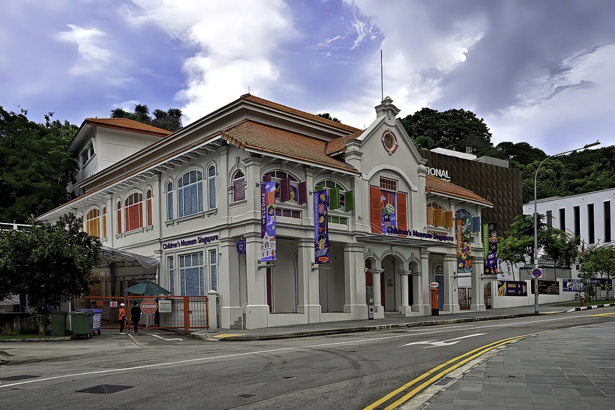 Angled corner view of Children's Museum Singapore showing the colourful banners and restored colonial-era architecture