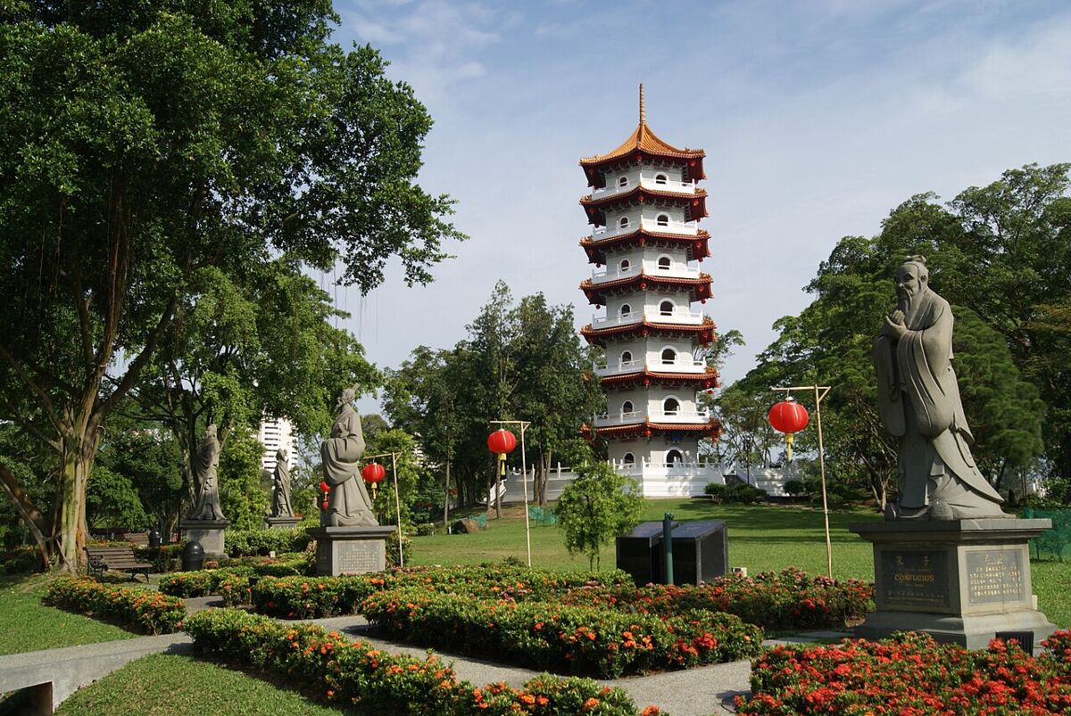 The seven-storey pagoda of Chinese Garden rising above lush trees under a blue sky in Singapore