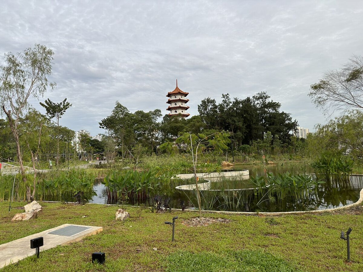 Chinese Garden pagoda viewed across a pond and grassy lawn with planted reeds