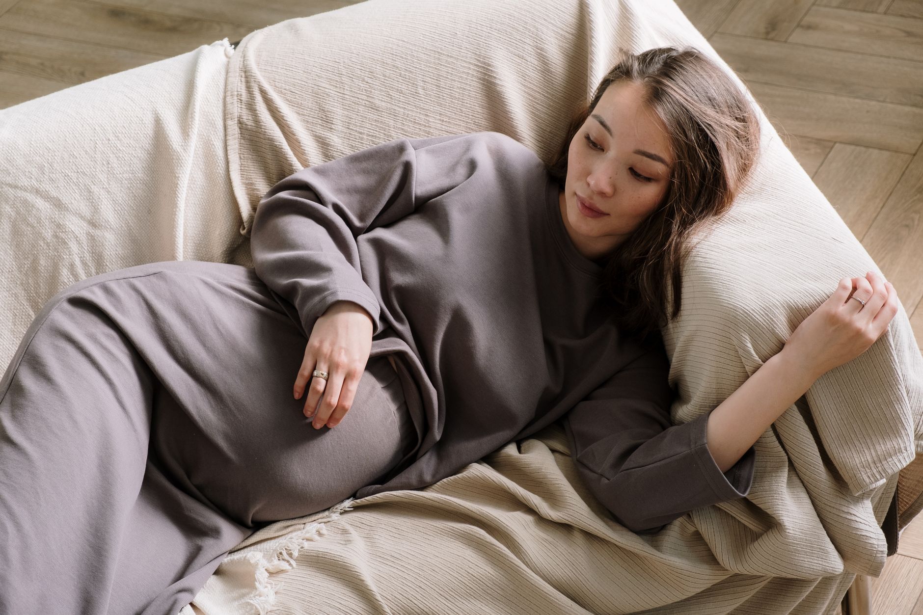 Pregnant woman lying on a comfortable sofa, embracing calm and relaxation