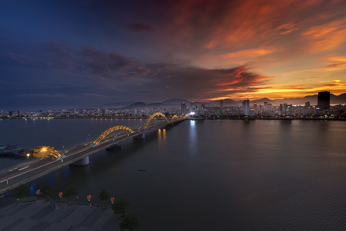 Da Nang city skyline and the Dragon Bridge over the Han River at sunset