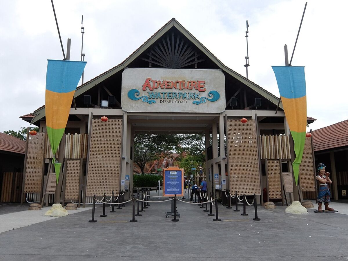 Timber entrance gate of Adventure Waterpark Desaru Coast with colourful banners
