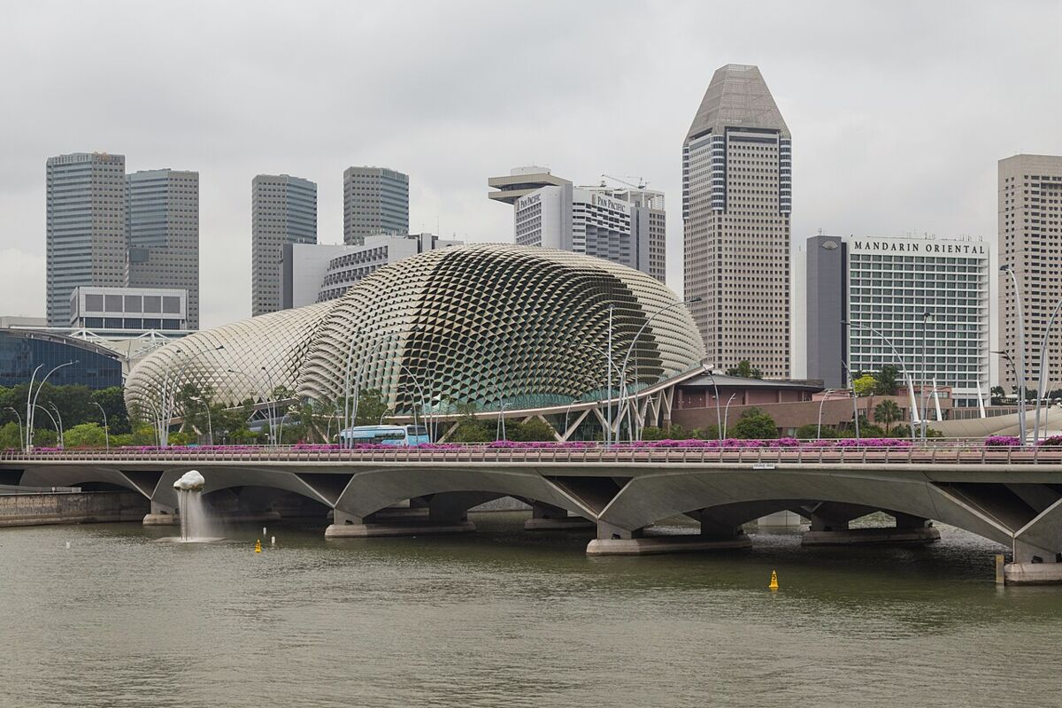 Esplanade Theatres on the Bay durian-shaped domes beside the Esplanade Bridge with the Singapore skyline behind by day