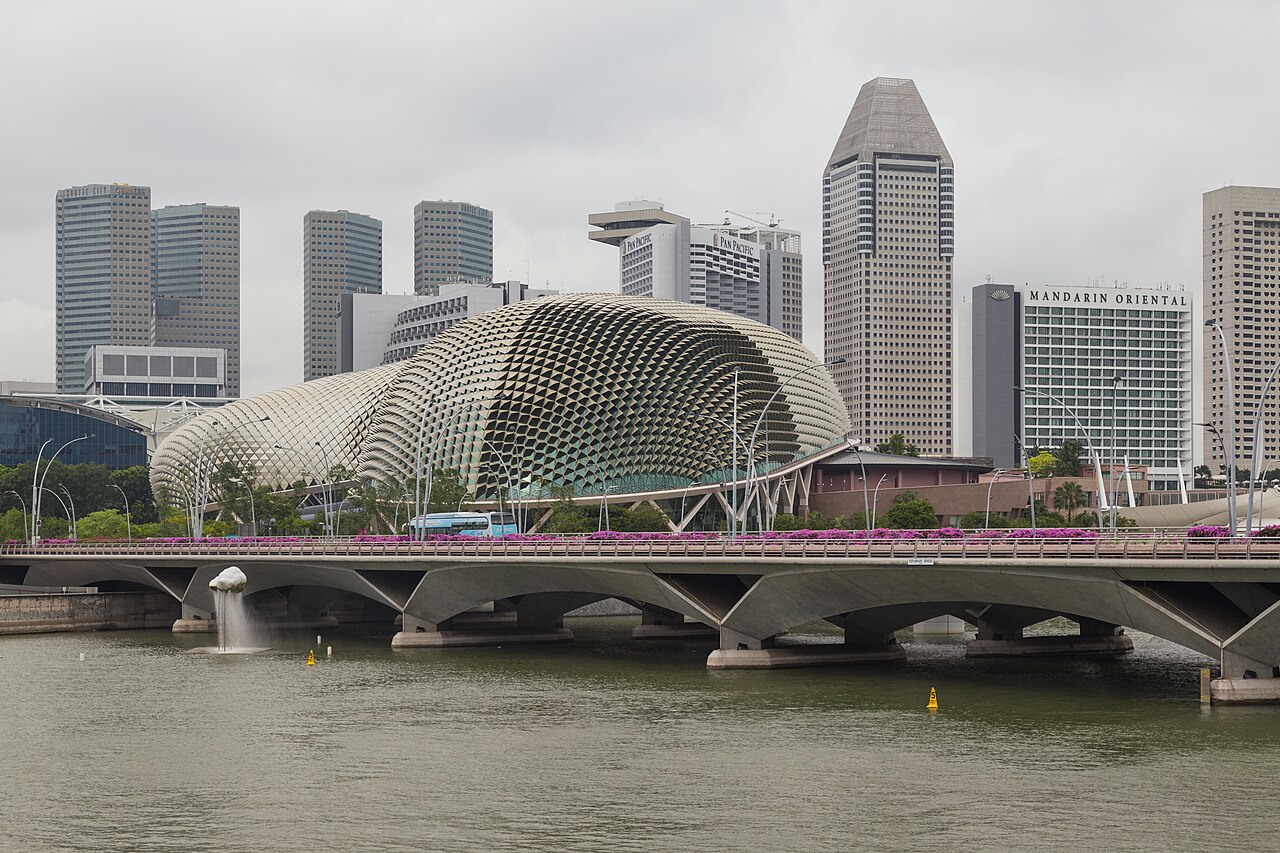 Esplanade Theatres on the Bay durian-shaped domes beside the Esplanade Bridge with the Singapore skyline behind by day