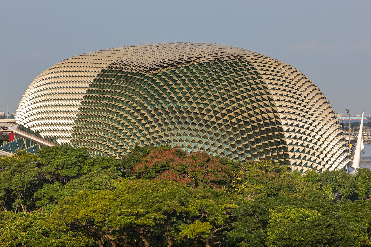 Close-up of the spiked aluminium-shaded dome roof of the Esplanade rising above lush tropical trees
