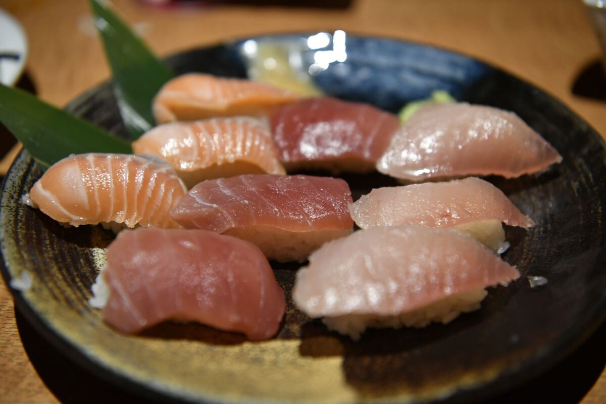 Close-up of delicious assorted nigiri sushi on a decorative plate featuring fresh seafood.