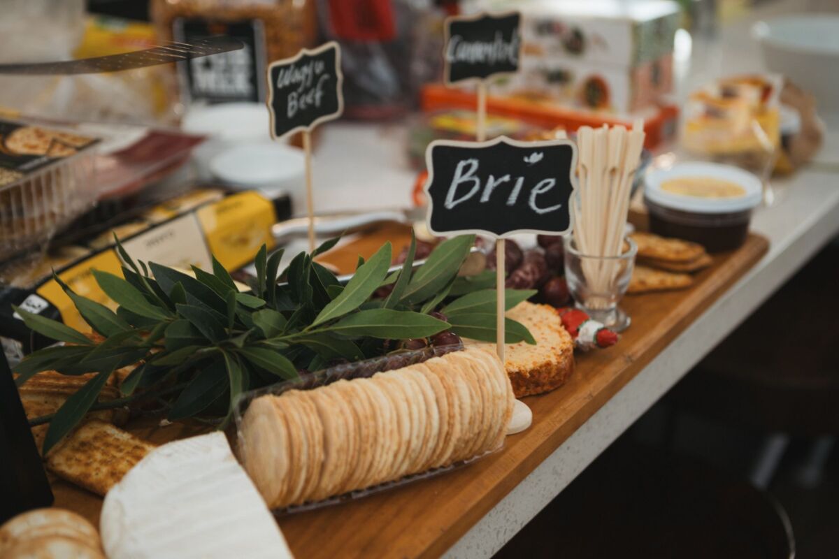 A delicious gourmet cheese platter featuring Brie cheese, crackers, and charcuterie.