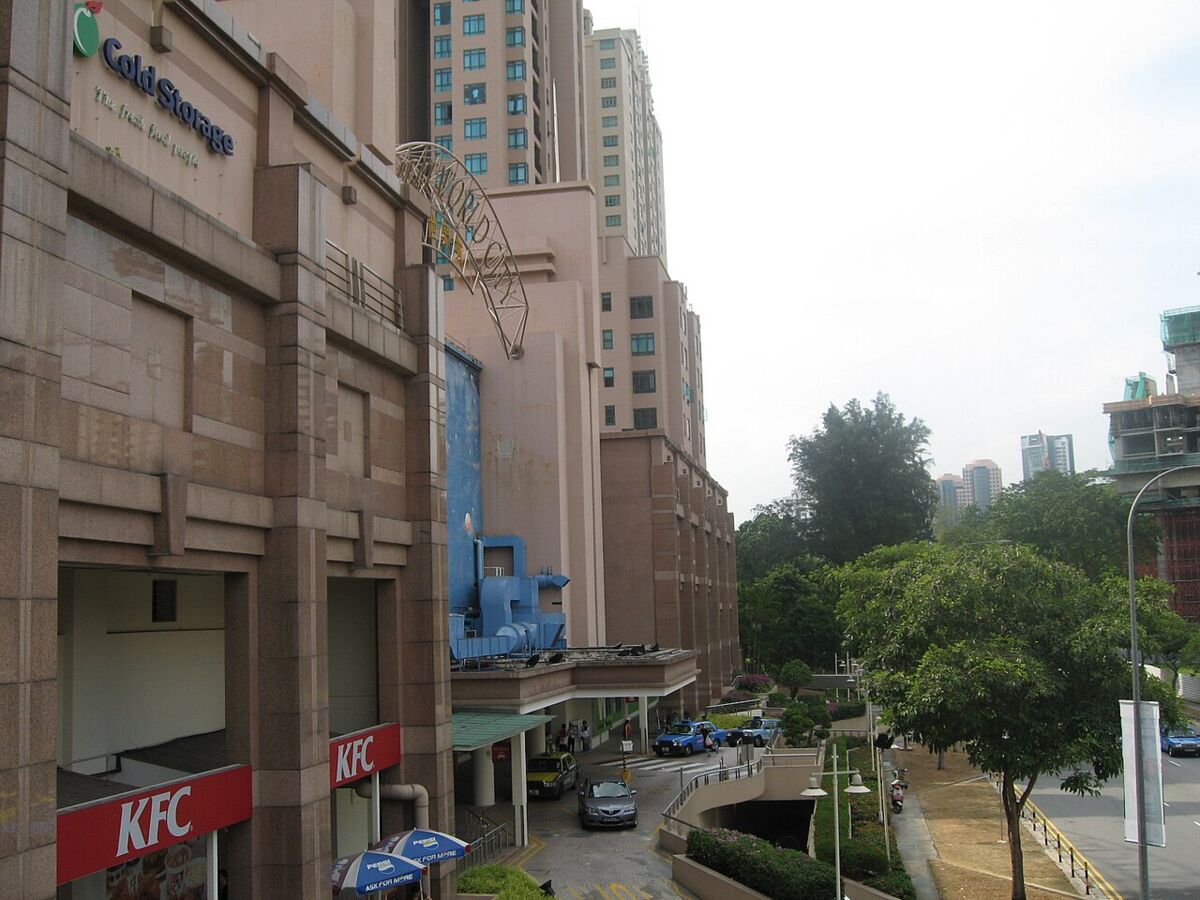 Street-level exterior view of Great World City showing Cold Storage and KFC entrances and the residential tower above, Singapore