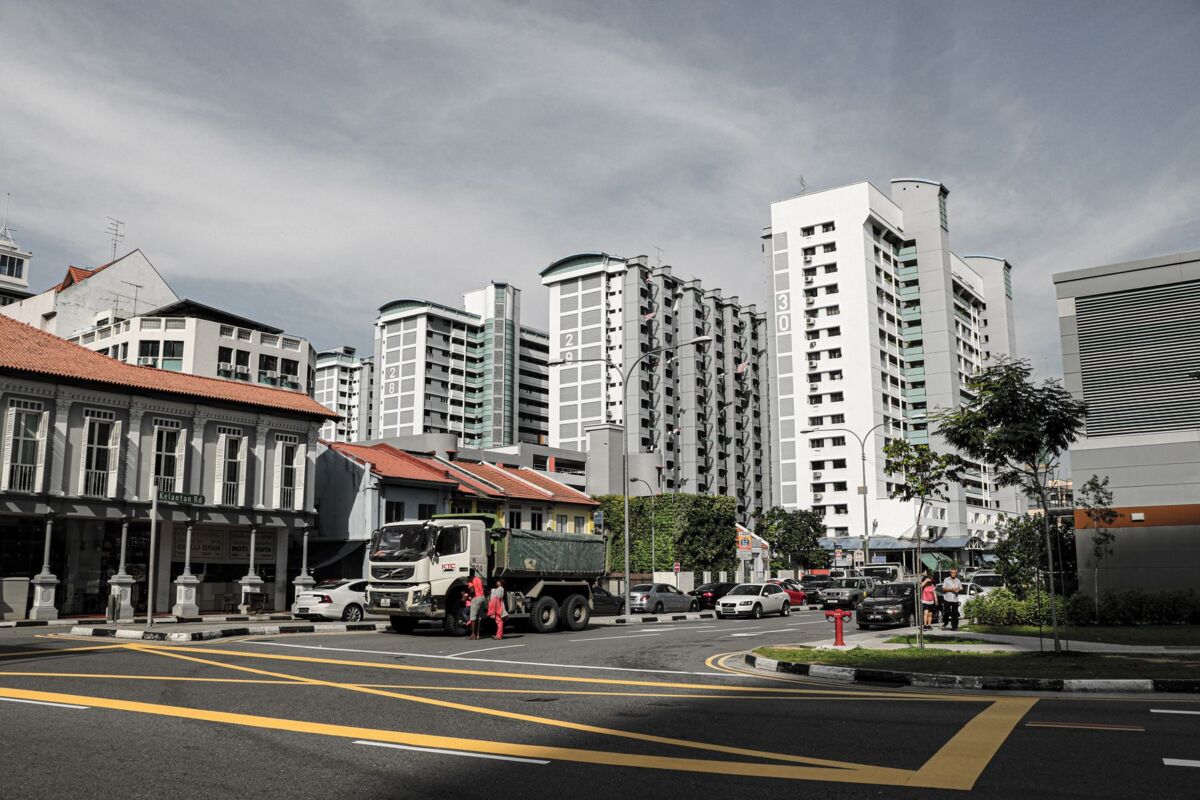 Street view of Singapore cityscape featuring high-rise buildings and urban streetscape.