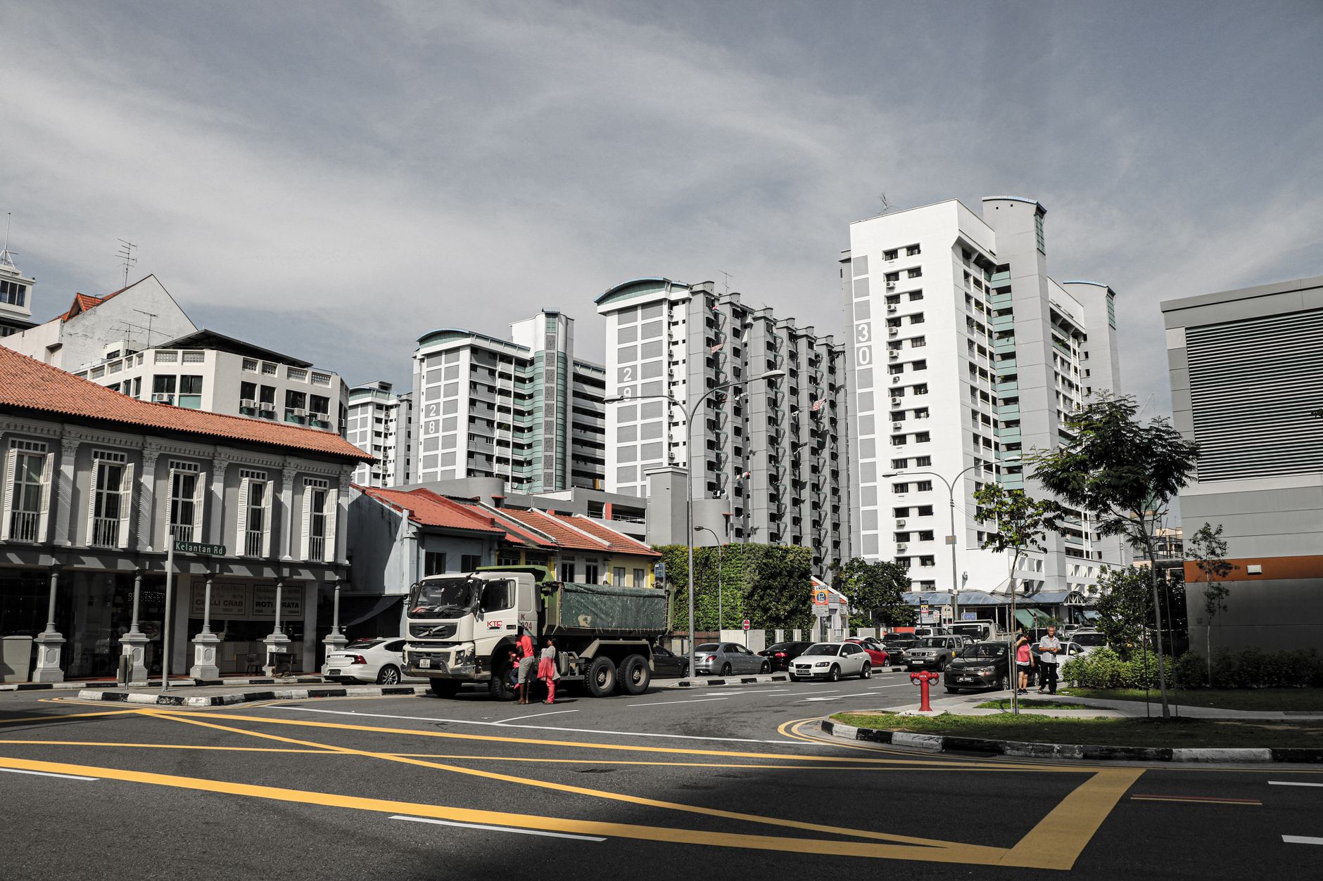 Street view of Singapore cityscape featuring high-rise buildings and urban streetscape.