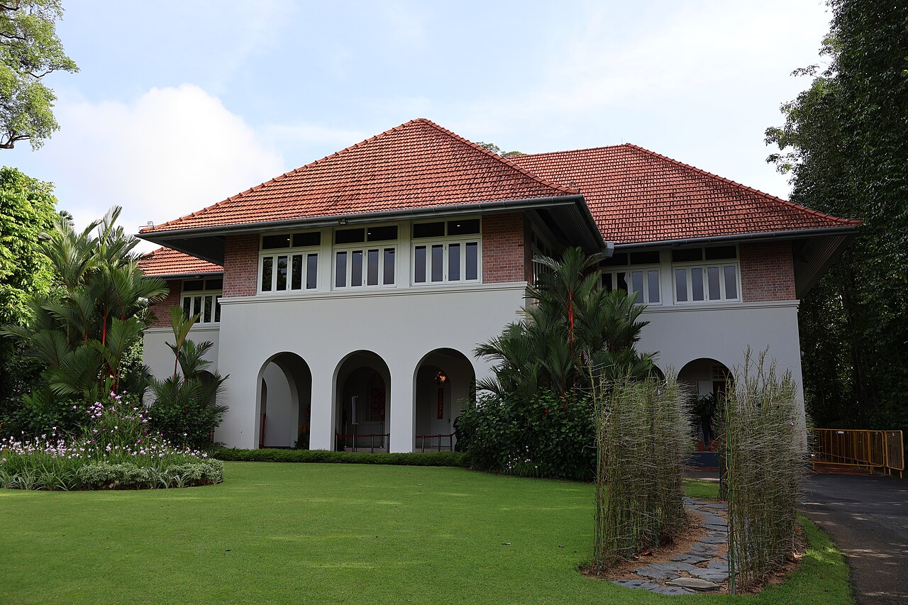 The Villa at the Istana, a red-roofed colonial bungalow with arched verandah and garden lawn