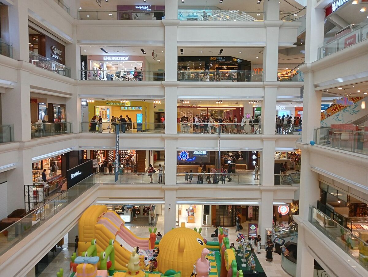 Interior atrium of Johor Bahru City Square mall with a colourful children's inflatable play area on the ground floor