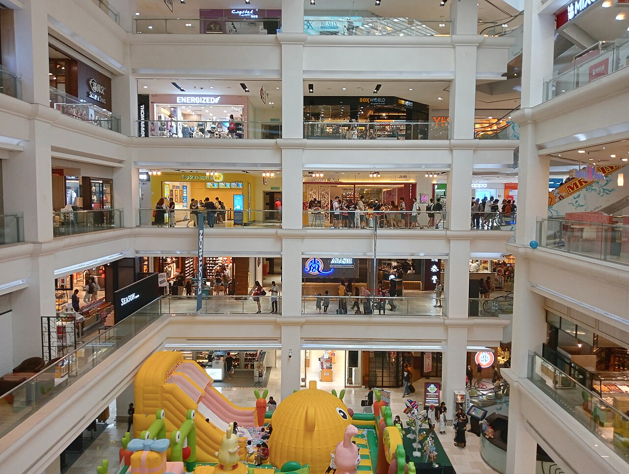 Interior atrium of Johor Bahru City Square mall with a colourful children's inflatable play area on the ground floor