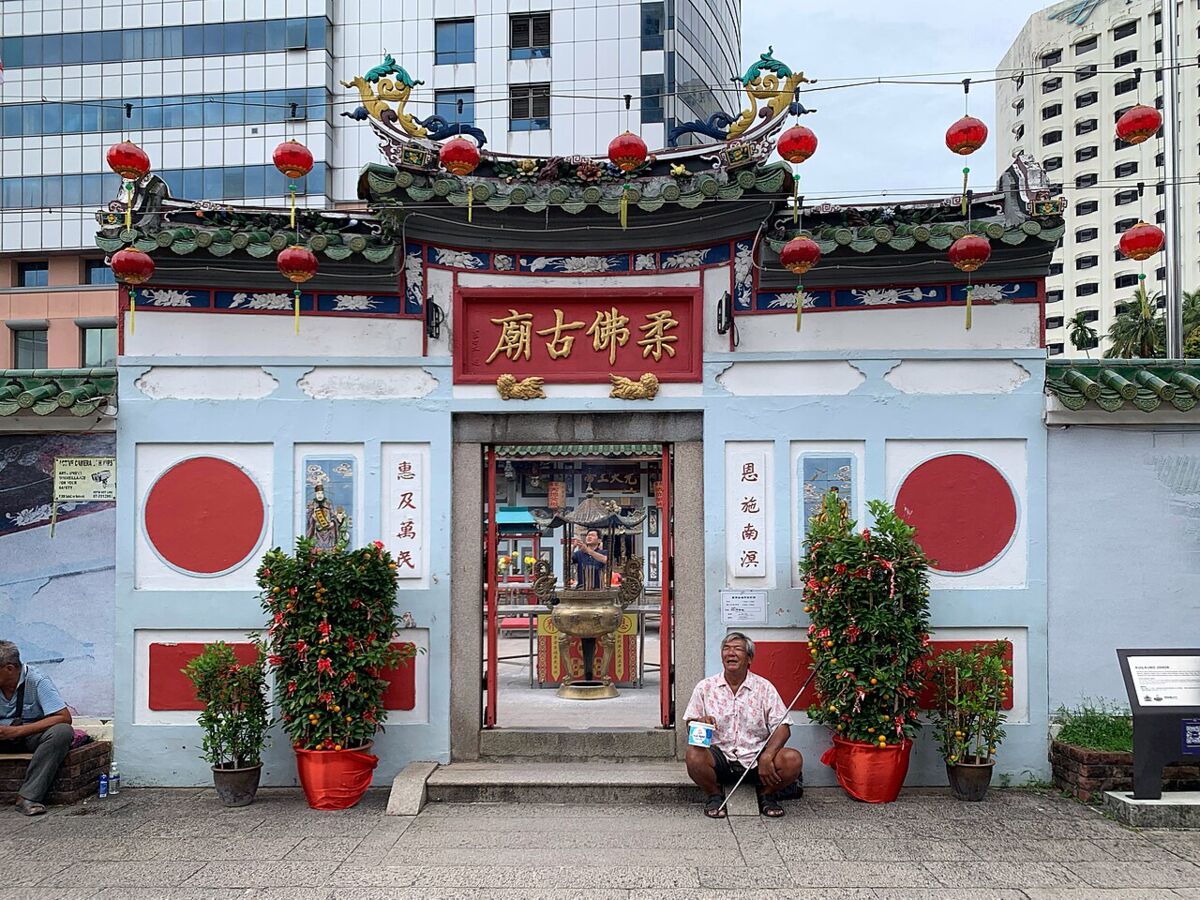 Ornate facade of the Old Chinese Temple in Johor Bahru with red lanterns and decorated rooftops