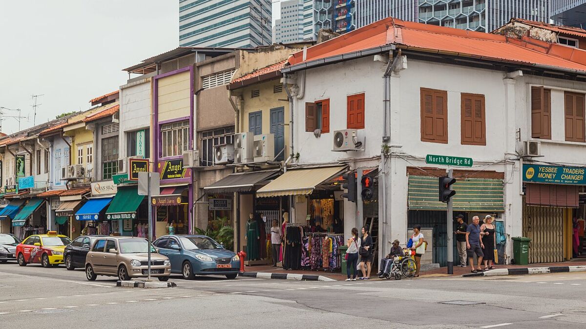 Heritage shophouses with shops and pedestrians at the corner of Arab Street and North Bridge Road in Kampong Glam, Singapore