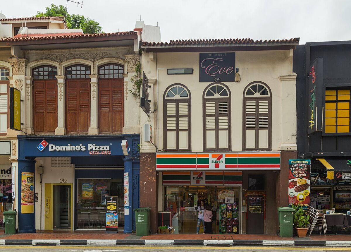 Restored two-storey shophouses with louvered windows and arched facades along Arab Street in Kampong Glam, Singapore