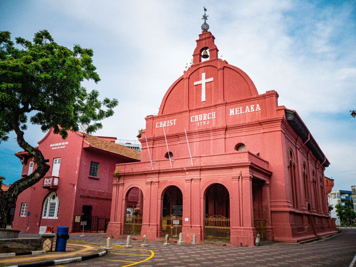 Iconic red Christ Church in the heart of Malacca, a renowned architectural and religious landmark in Malaysia.