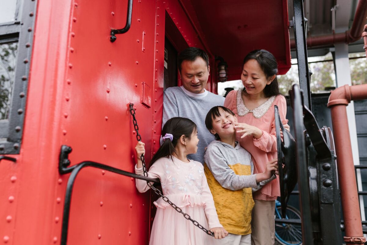 A joyful Asian family bonding on a train, highlighting love and togetherness.