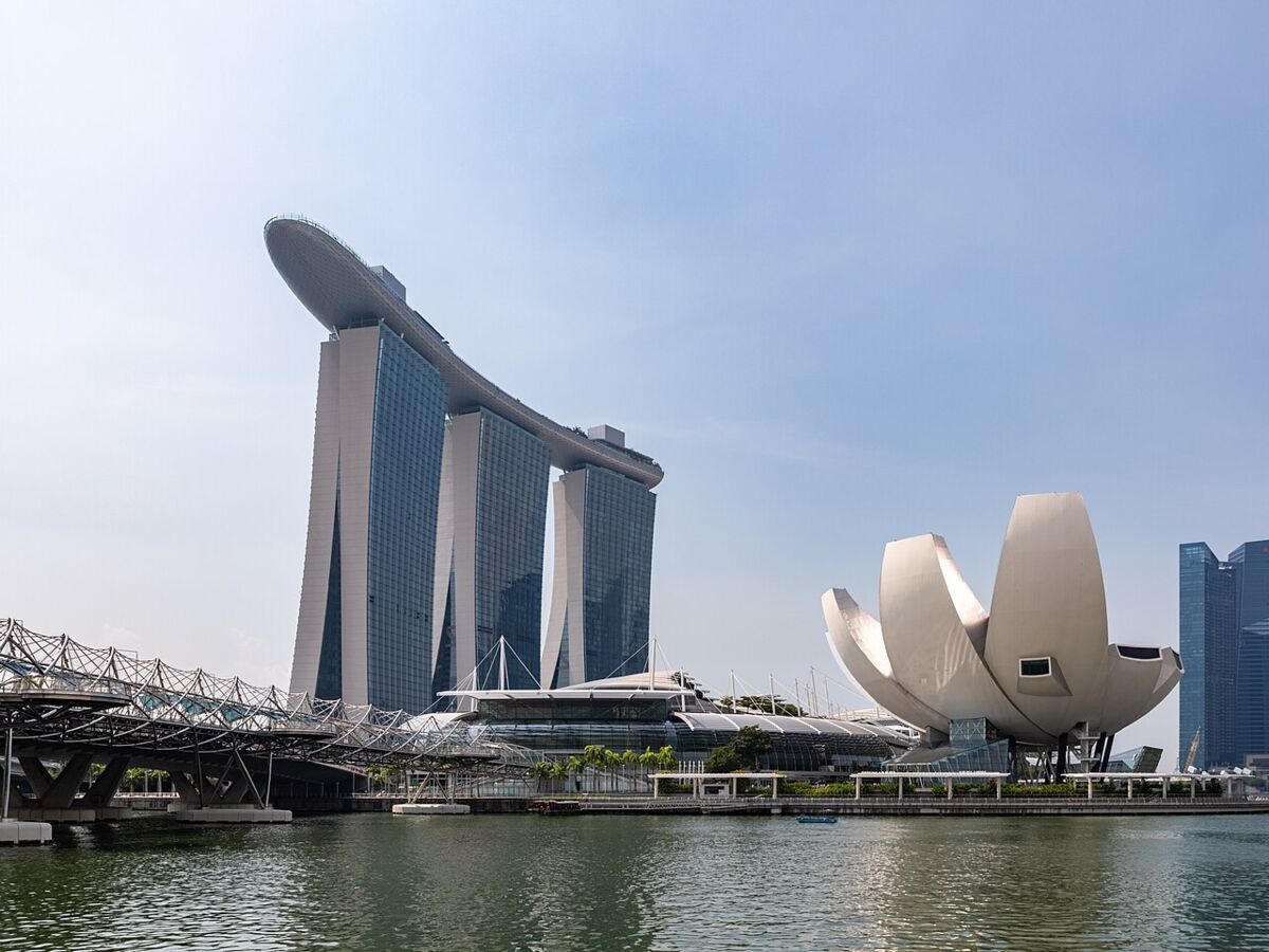 Daytime view of Marina Bay Sands with the Helix Bridge and lotus-shaped ArtScience Museum across the water