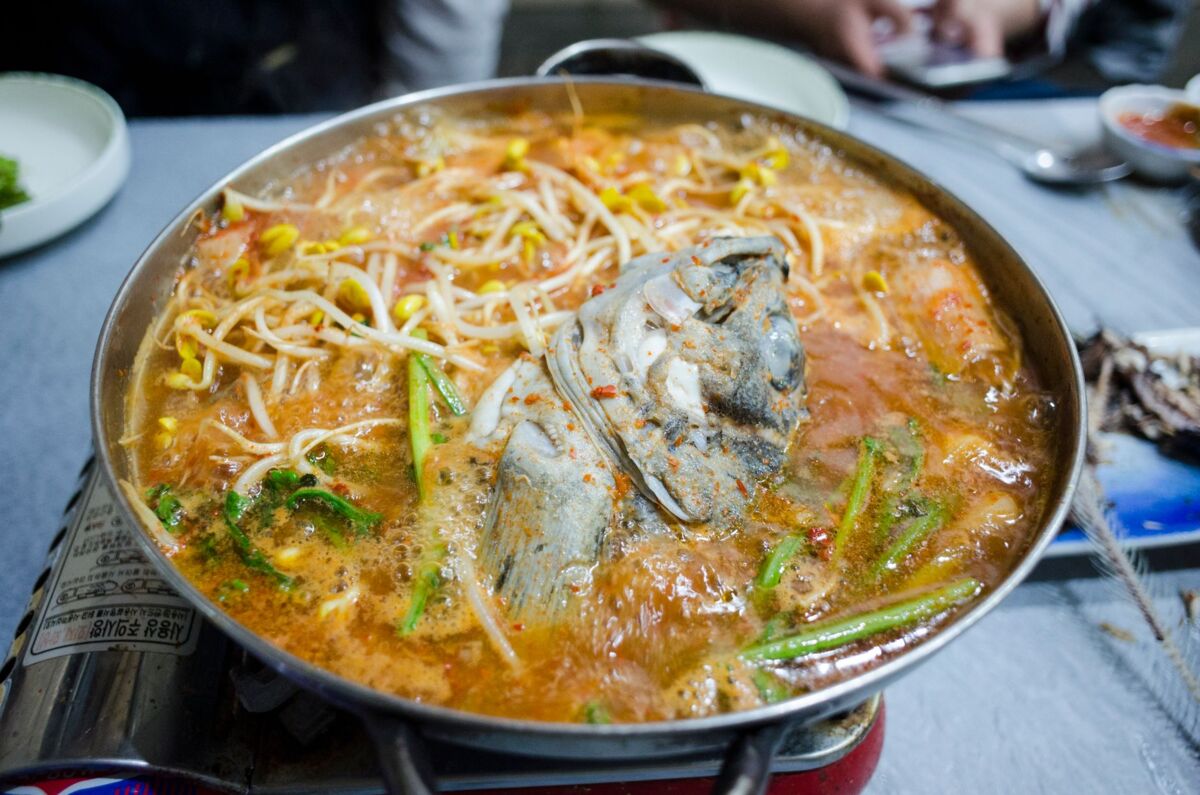 Delicious spicy seafood hotpot with fresh vegetables and bean sprouts, perfect for a warm meal.