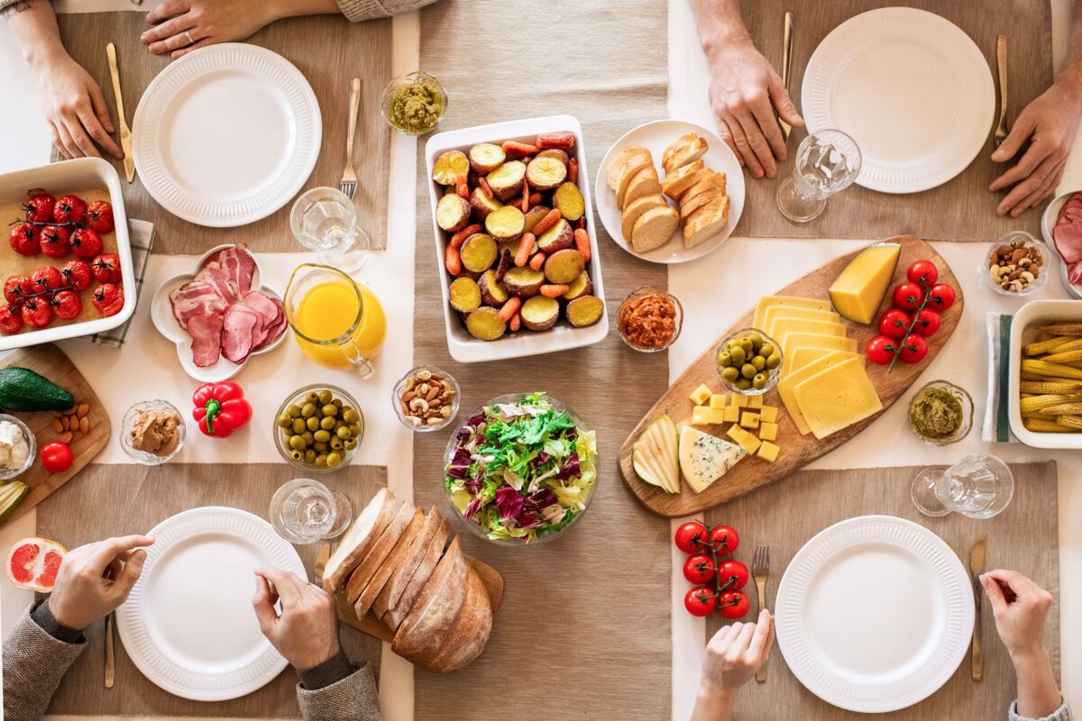 An overhead shot of a diverse, appetizing spread on a dining table ready for a meal.