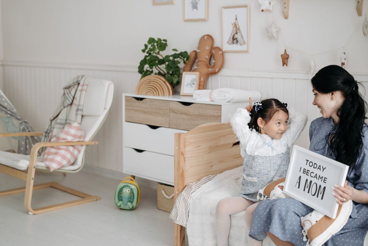 A joyful mother and daughter share a special moment indoors with a heartwarming message.
