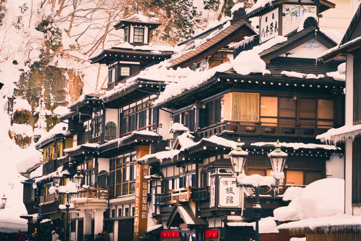 Quaint Japanese buildings covered in snow, showcasing traditional architecture during winter.