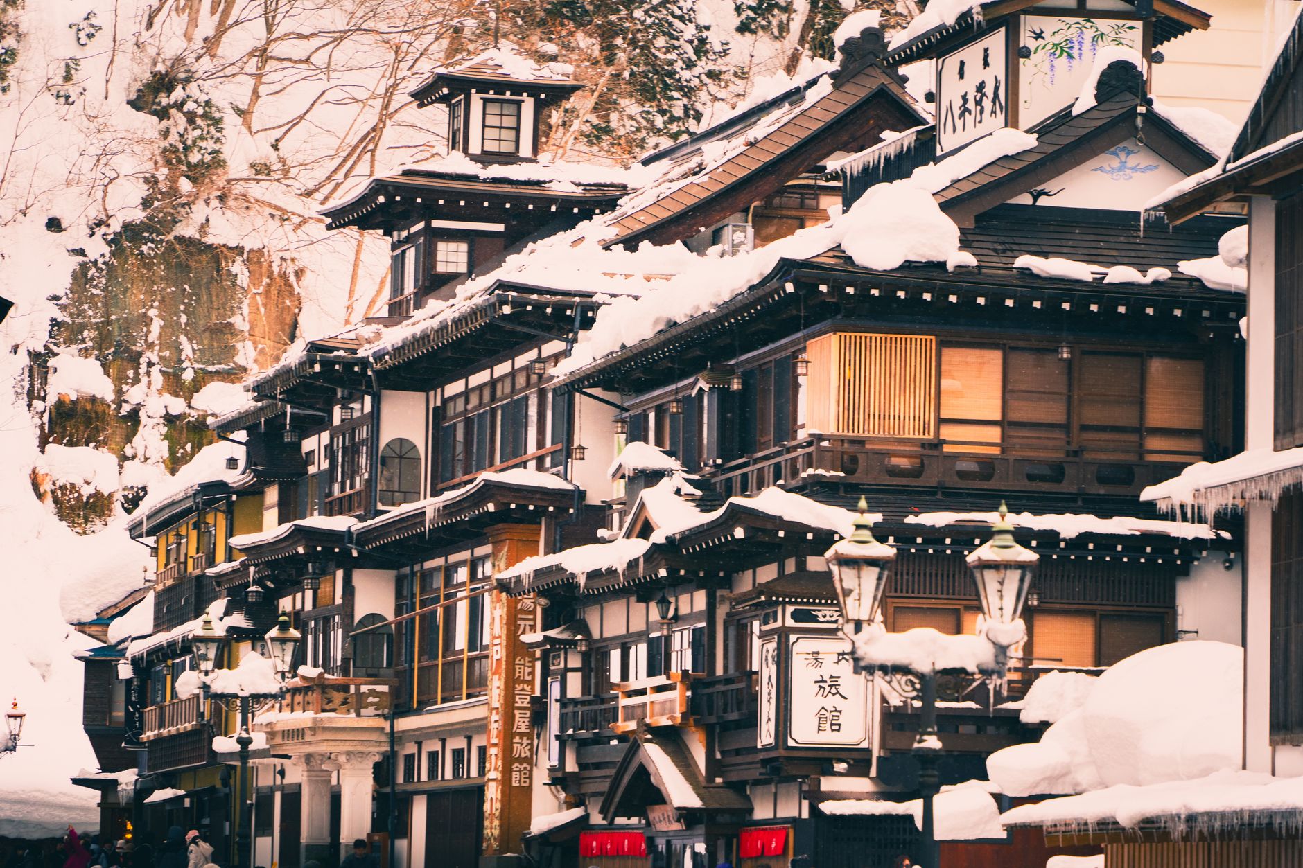 Quaint Japanese buildings covered in snow, showcasing traditional architecture during winter.