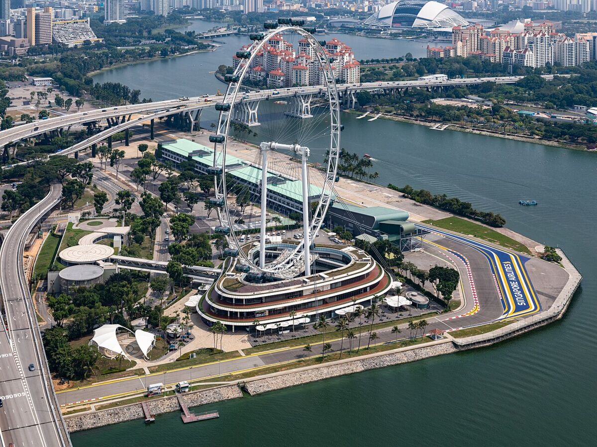 Aerial view of the Singapore Flyer observation wheel and its terminal building beside Marina Bay