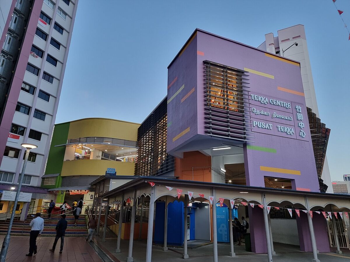 Colourful purple and yellow exterior of Tekka Centre with its signage at dusk