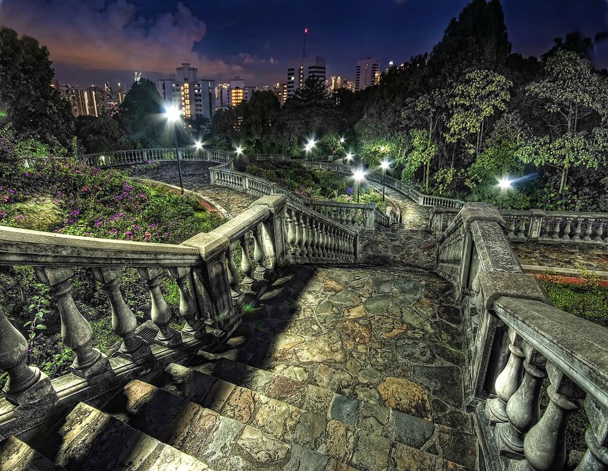 Stone staircase and balustrades of the Terrace Garden at Telok Blangah Hill Park with the city skyline behind