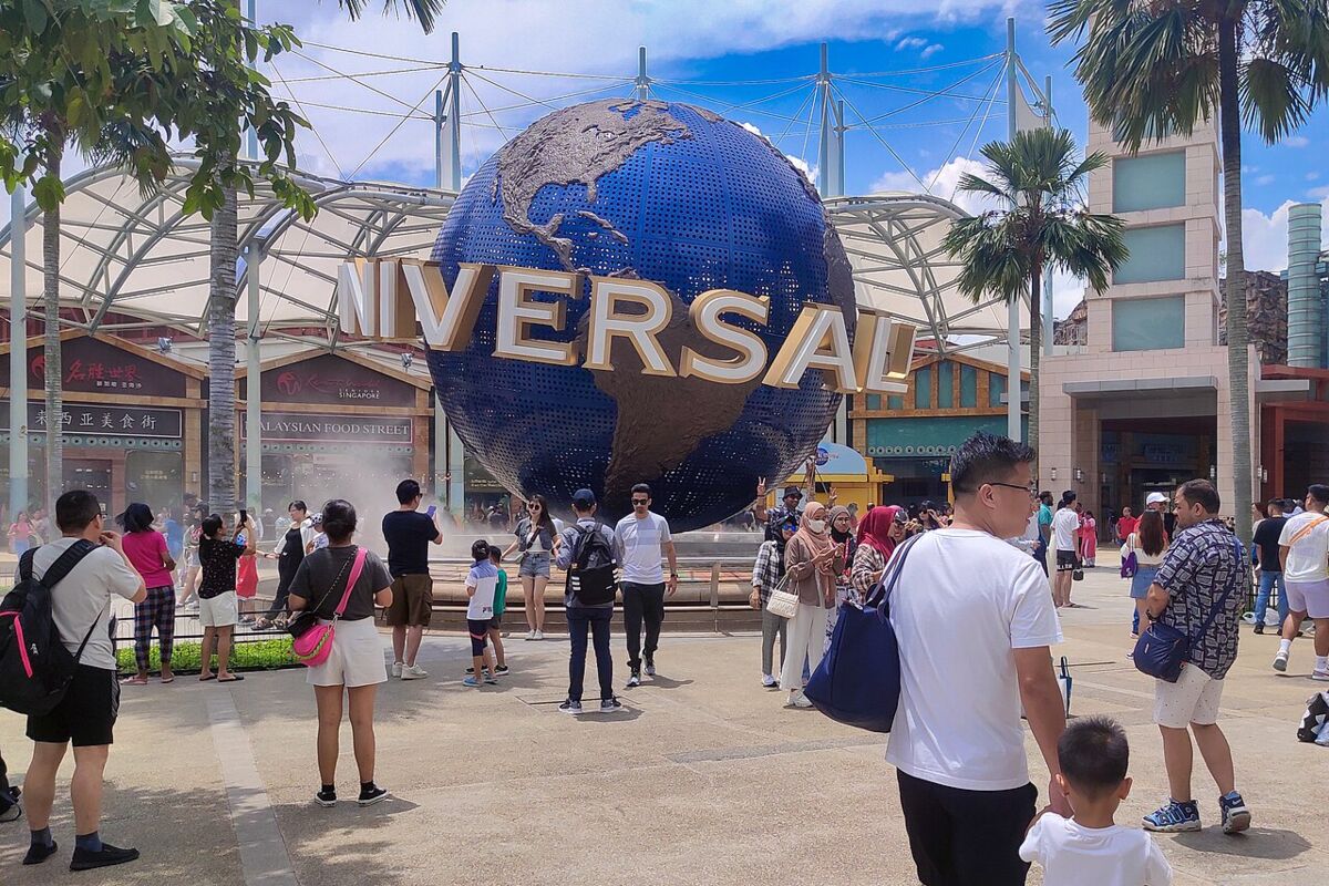 Visitors gathered around the iconic rotating Universal globe at the entrance to Universal Studios Singapore