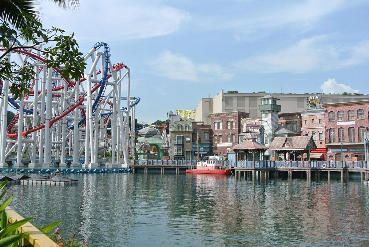Roller coaster tracks beside the New York-themed waterfront streetscape across the lagoon at Universal Studios Singapore
