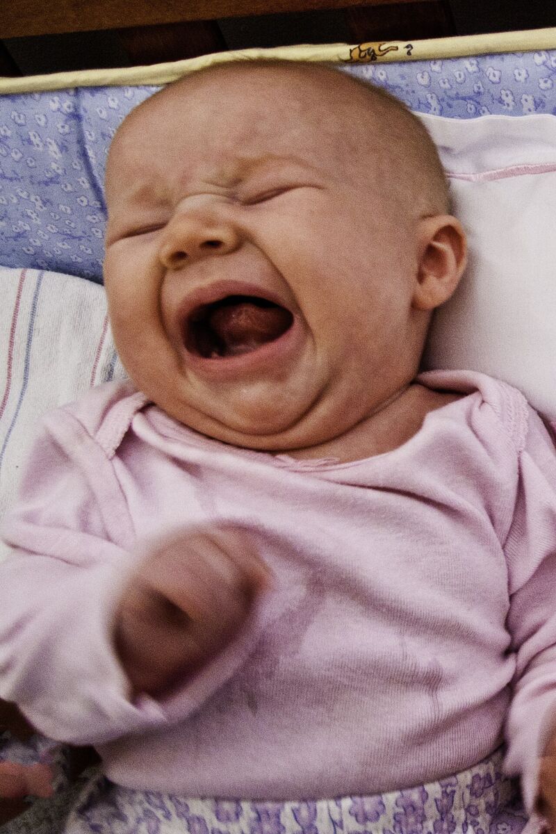 A crying baby communicating a need