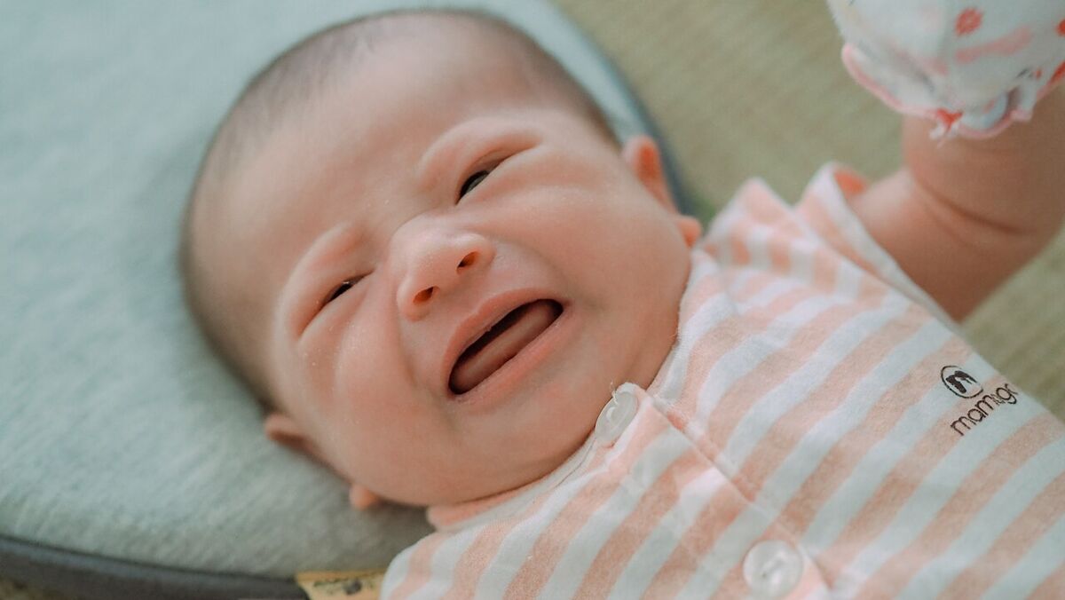 A crying baby communicating a need
